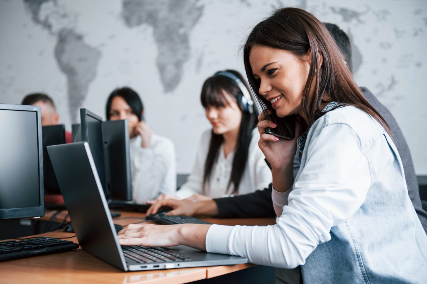 Young people working in the call center. New deals is coming.